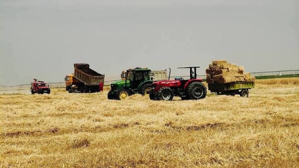 Farm equipment and hay bales during the cereal harvest