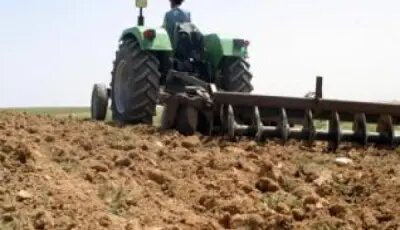 Tractor preparing the field for the next planting